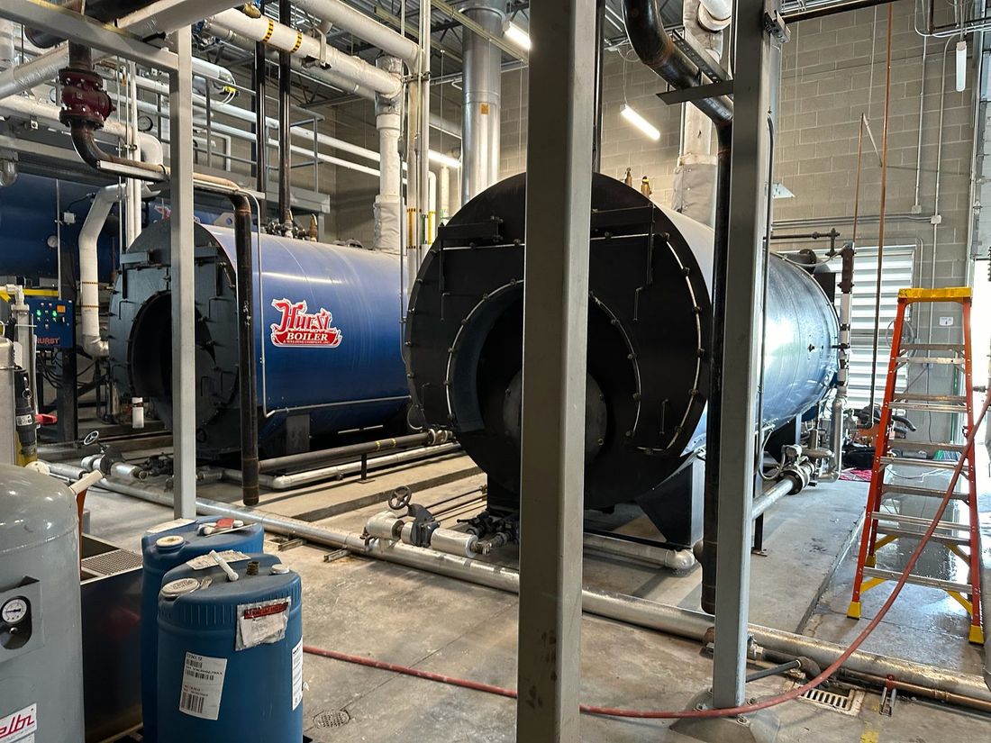 Commercial mechanical room with boilers, piping and expansion tanks